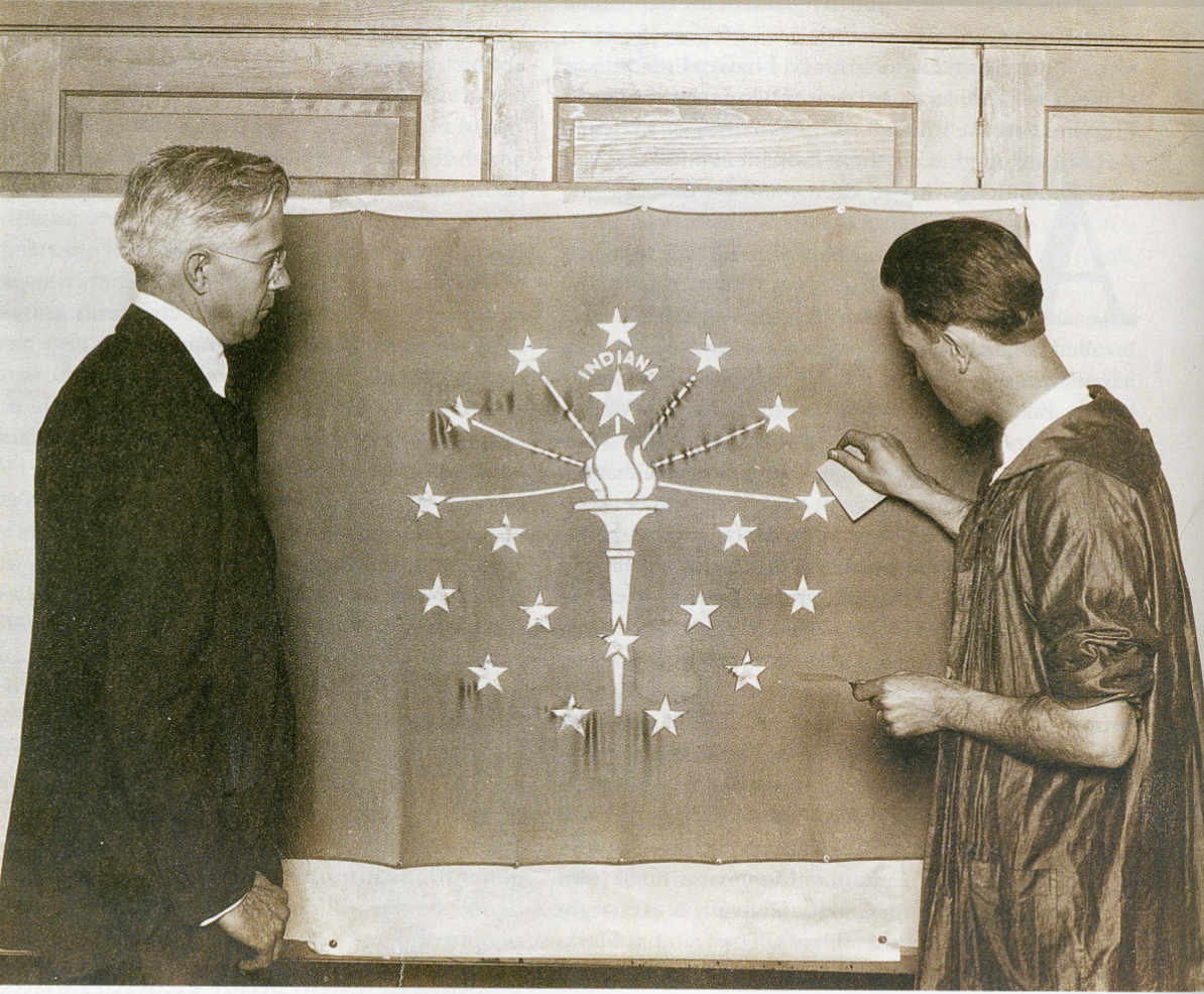 Paul Hadley standing by his design of the Indiana State Flag